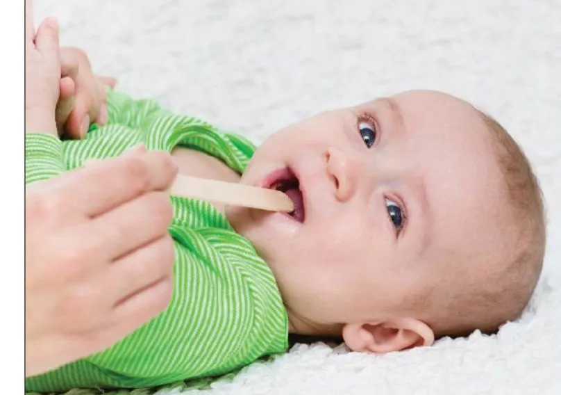 Baby being examined for cleft palate