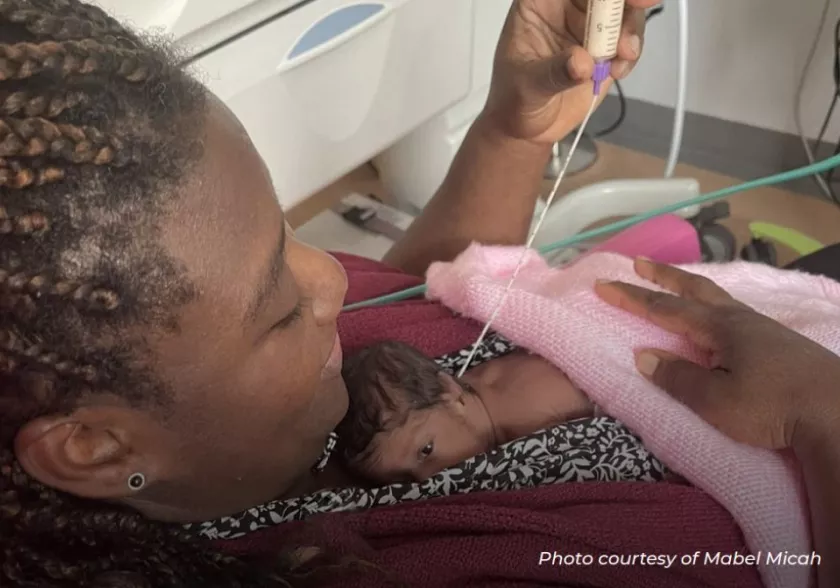 Photo of woman holding her small baby in a hospital environment