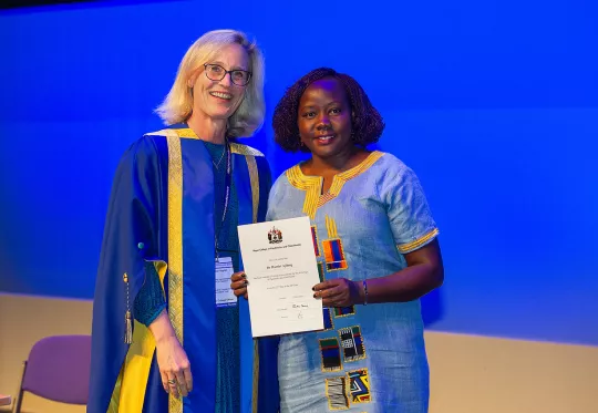 Woman receiving award at conference