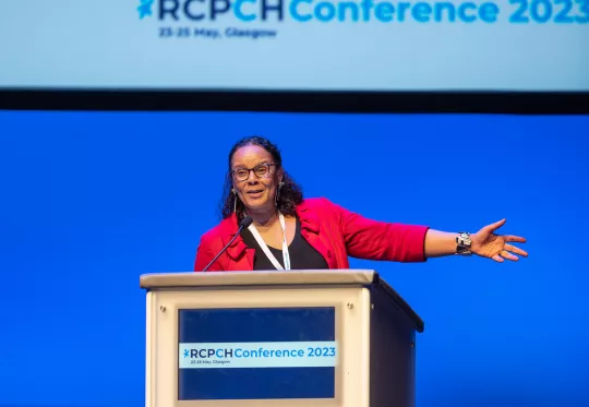 Middle aged woman speaking at podium