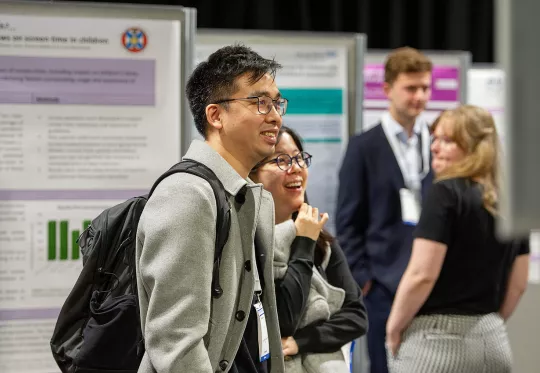 Man and woman looking at poster exhibit
