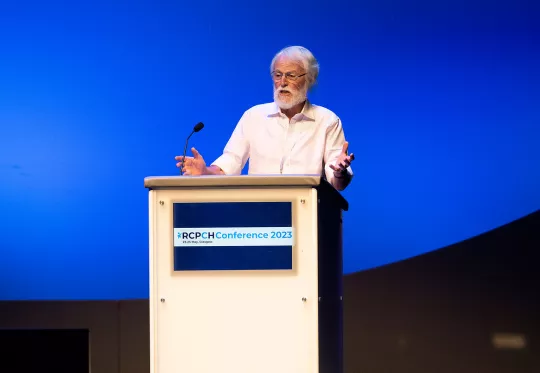 Older man speaking at podium 