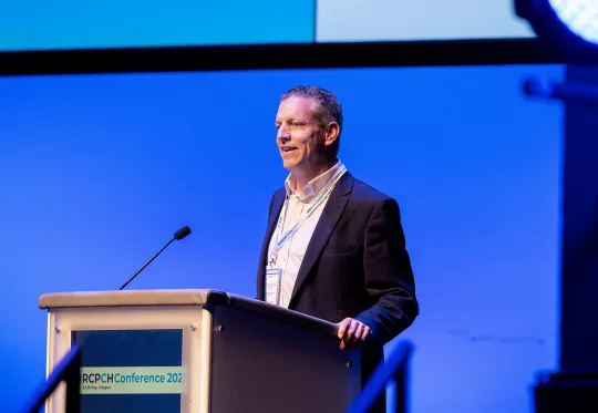 Man speaking at podium at conference