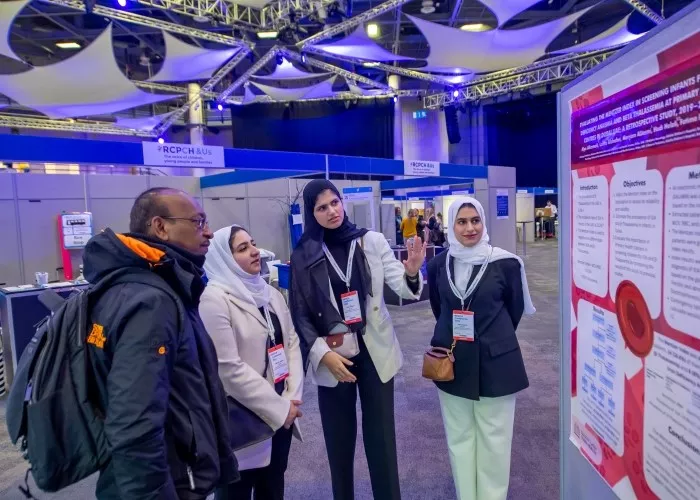 Group of people looking at posters in an exhibition hall