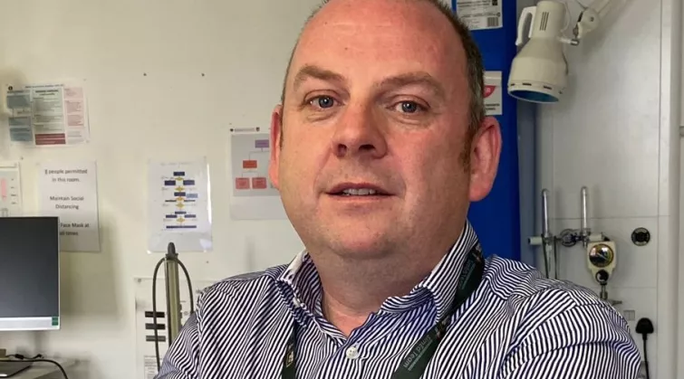 Photo of Dr Thomas Bourke at work in a hospital ward