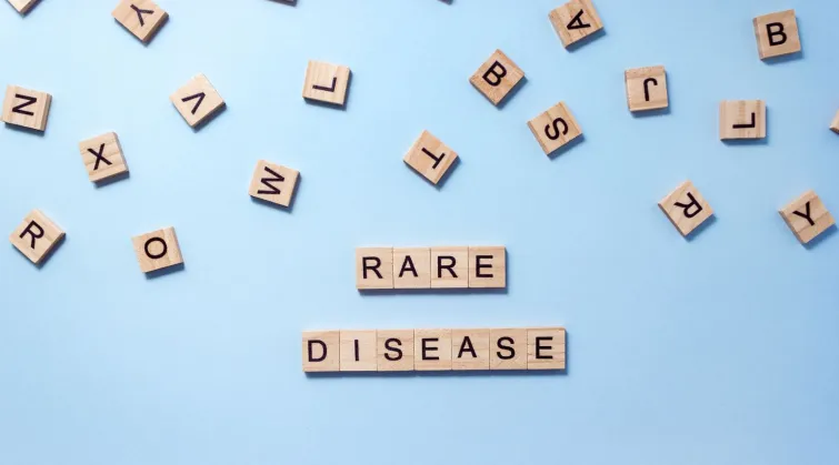 Alphabet titles spilled on table with some lined up to spell 'RARE DISEASE'