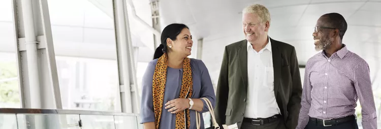 Three people in a hospital setting talking 