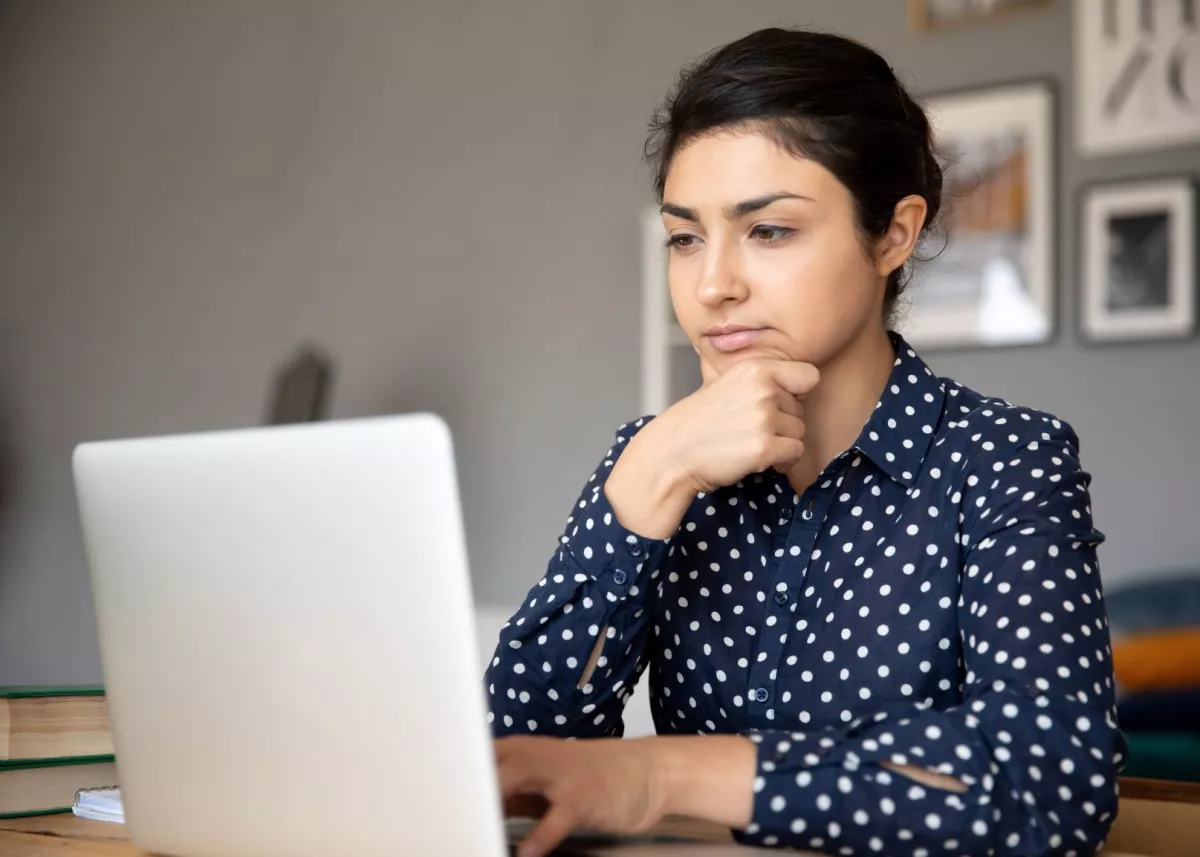 Woman looking at her laptop, studiously