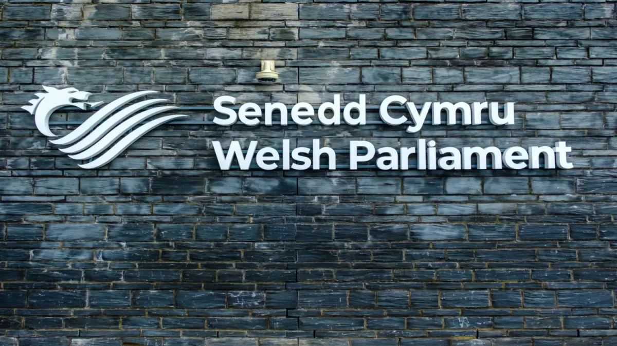 Sign on building: Senedd Cymru | Welsh Parliament