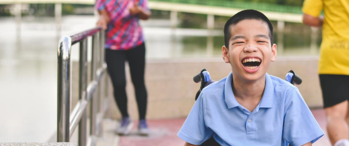 Boy in wheelchair has a huge smile