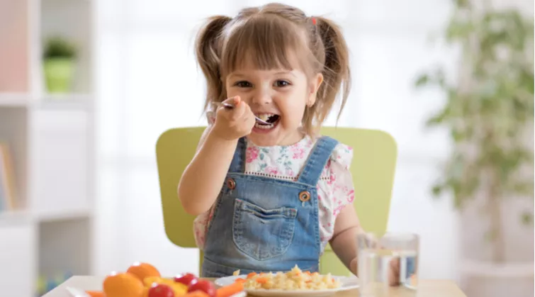 Young girl eating a healthy meal