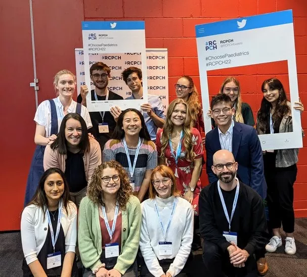 A group of medical students, some with oversized picture frames, at RCPCH Conference 2022