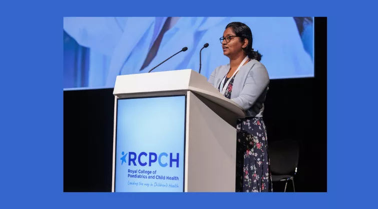 Dr Sharmila Manivannan speaking from podium with RCPCH logo 