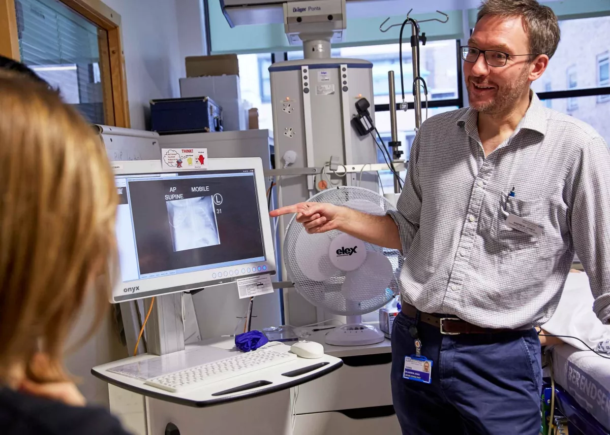 Doctor teaching clinic with computer