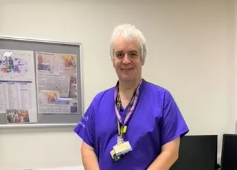 Steve Jones in scrubs at his workplace