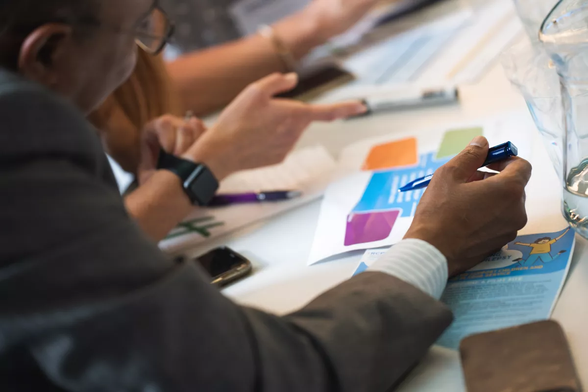 Close up of a group looking at papers, from an EQIP shared learning event 