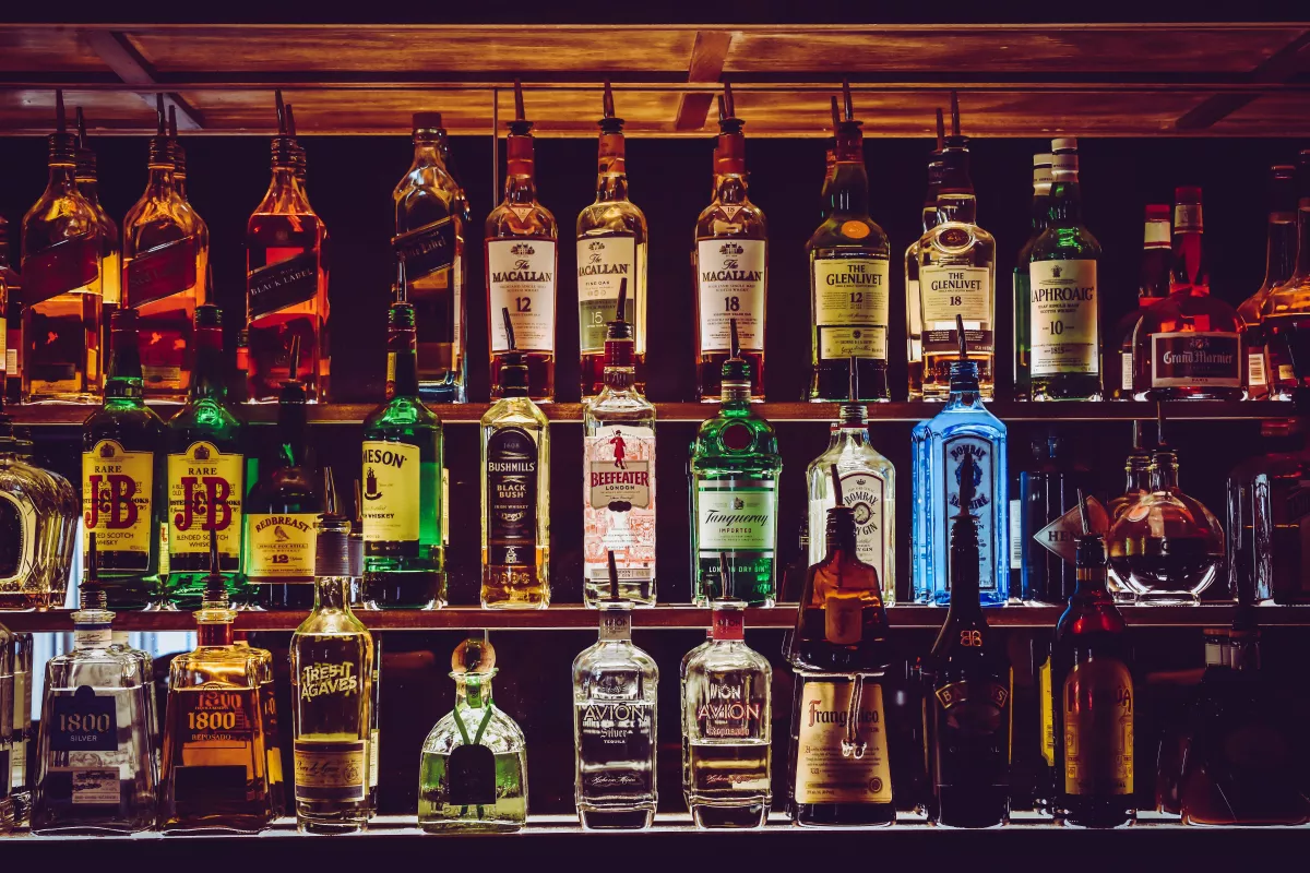 Lots of bottles of alcohol behind a bar