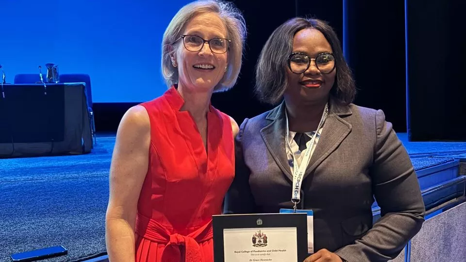 Two women posing with a certificate