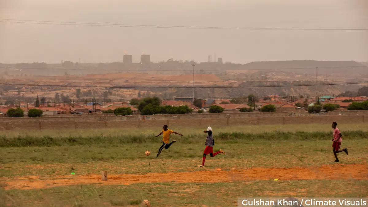 Children playing football in polluted air
