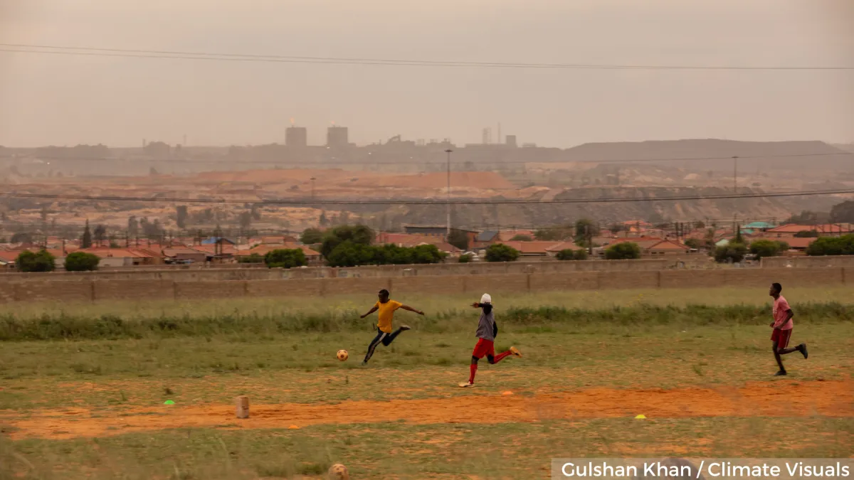 Air pollution: playing outside Children playing football in polluted air