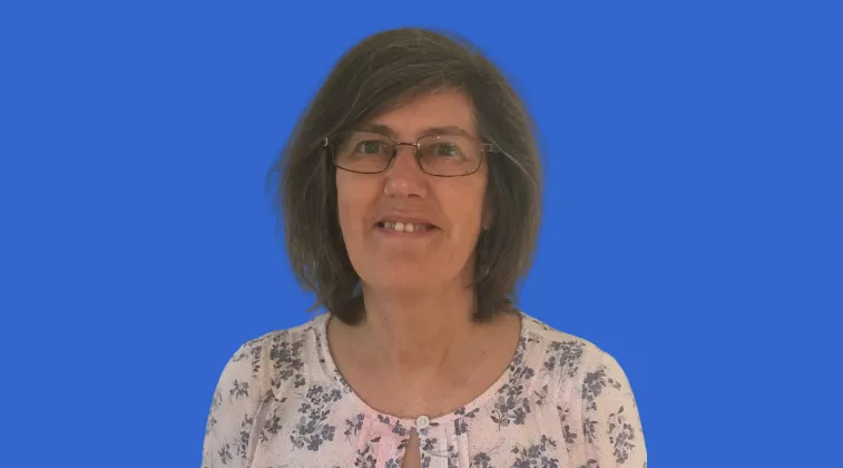 Photo of Rosamund Jones: woman smiling with flower top