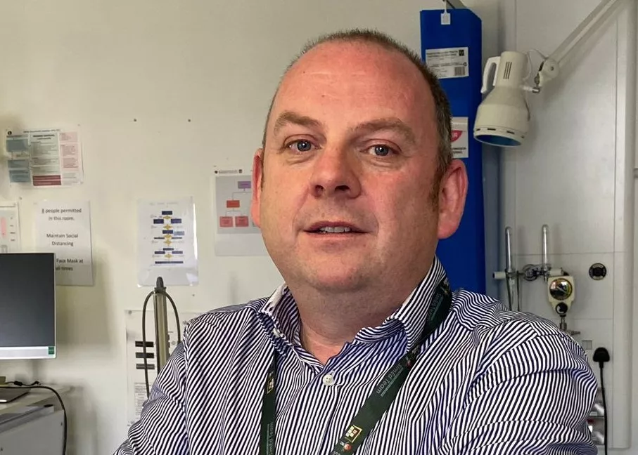 Photo of Dr Thomas Bourke at work in a hospital ward