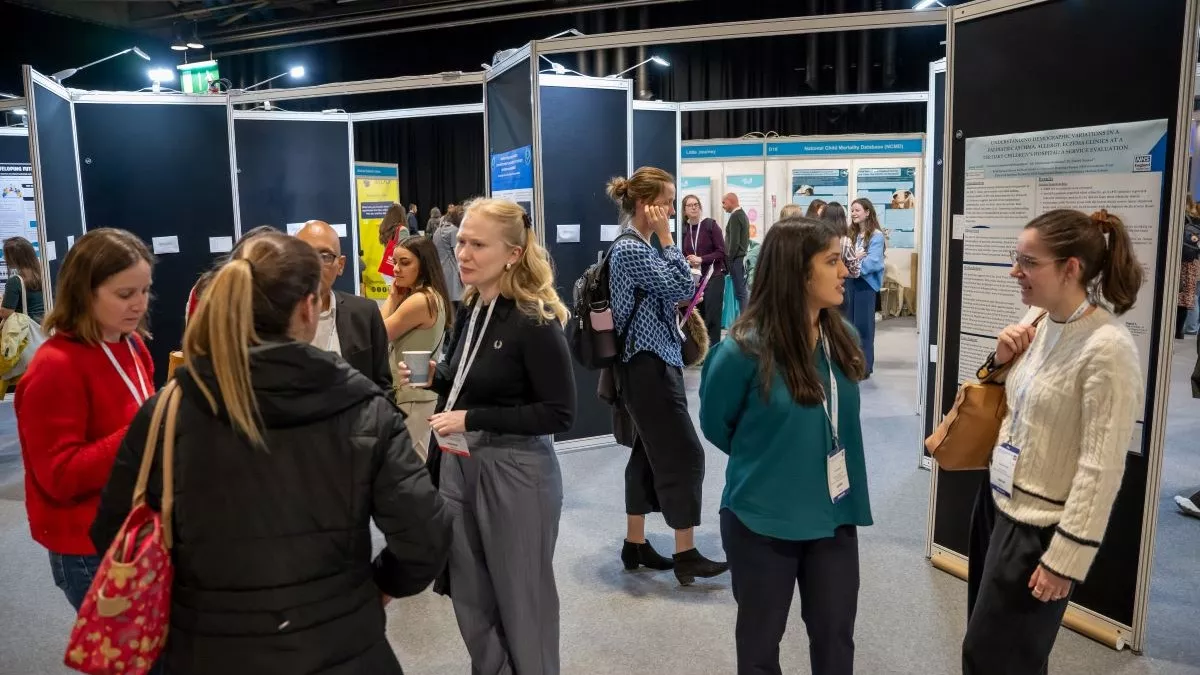 Delegates talking with each other and looking at posters at RCPCH Conference