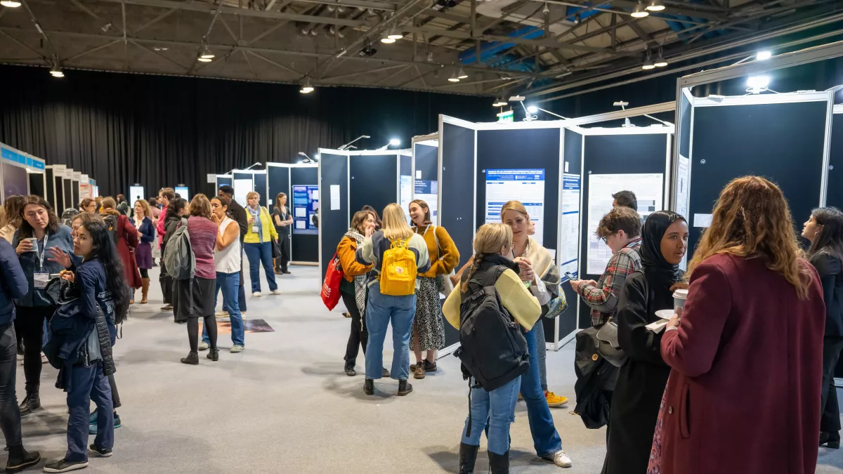 People talking and looking at posters