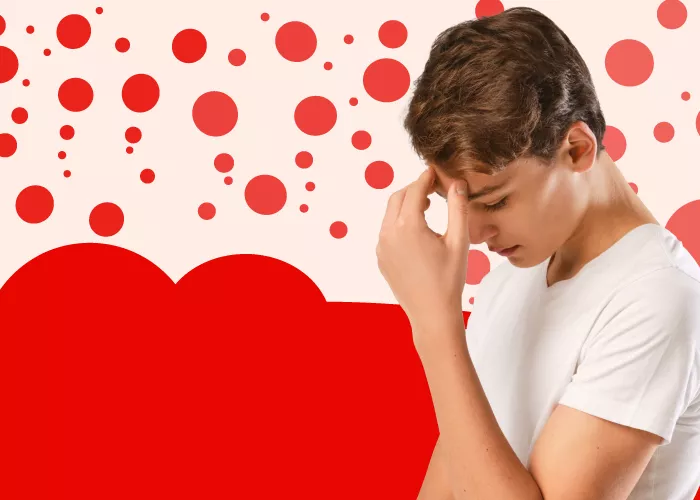 Think measles - boy with head in his hand - red dot background