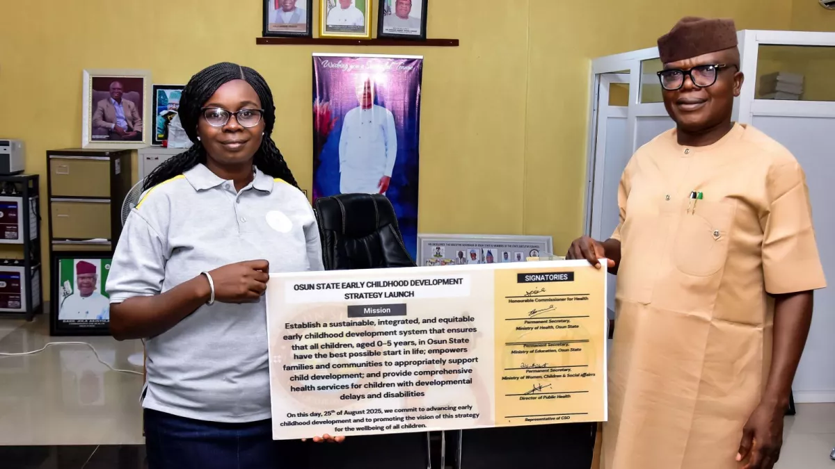 Two people hold up a large sign reading Osun State Early Childhood Strategy Launch