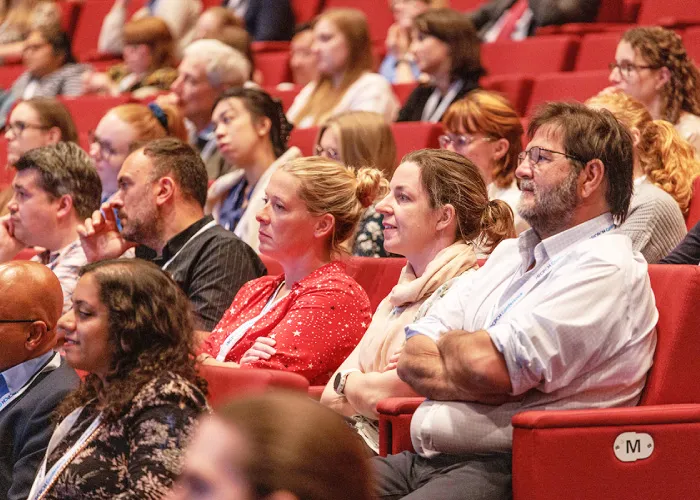 Delegates at a conference, seated in a theatre