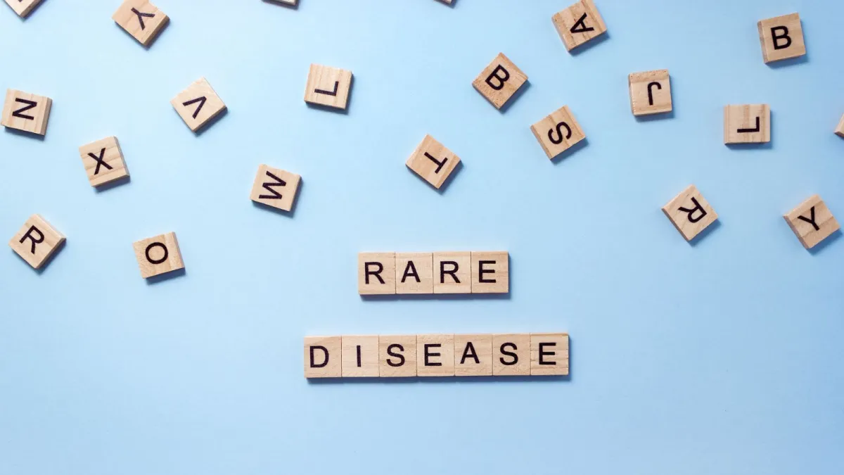 Alphabet titles spilled on table with some lined up to spell 'RARE DISEASE'