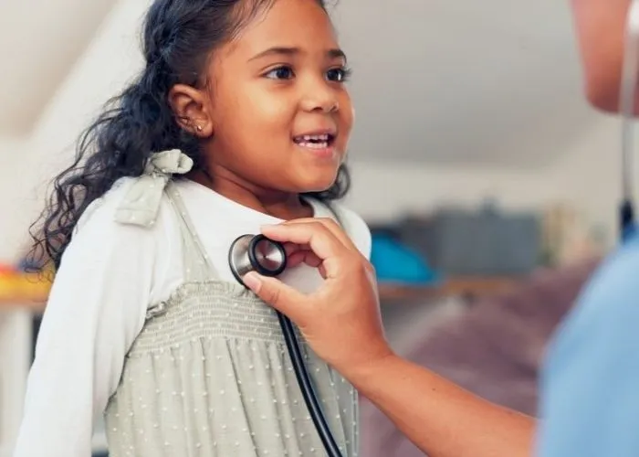 Young girl getting her heart checked with a stethoscope
