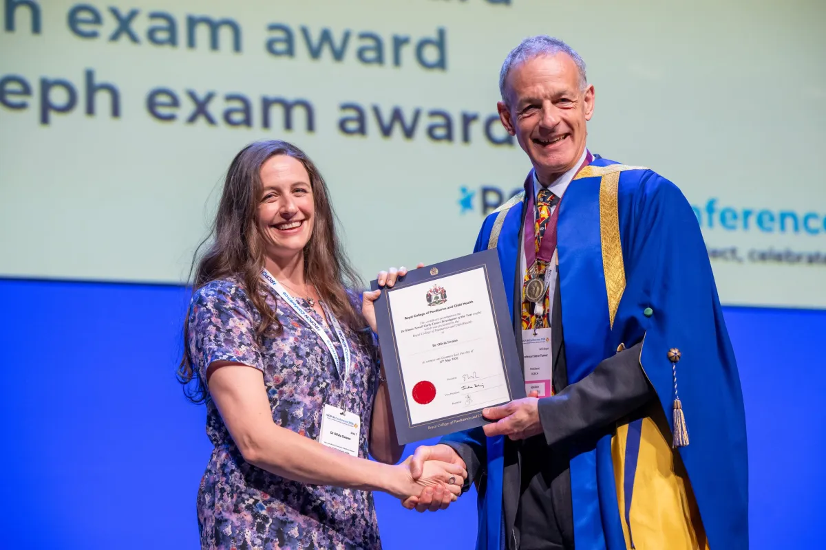 Dr Simon Newell Award Winner accepts certificate