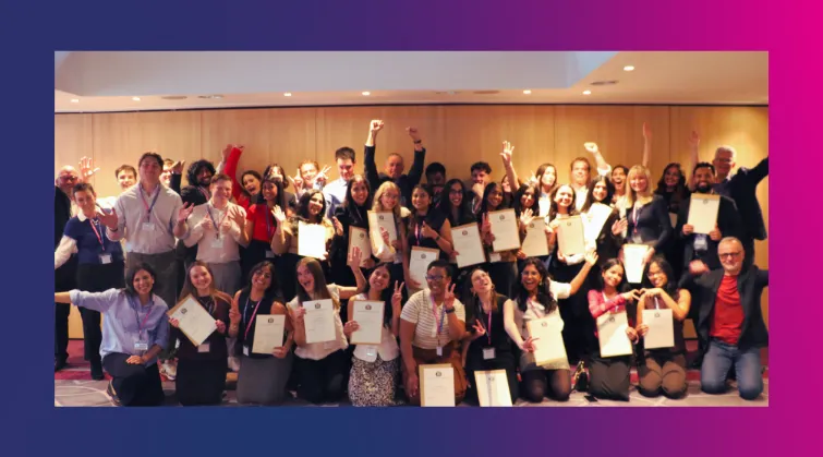 Group of people holding up certificates and smiling