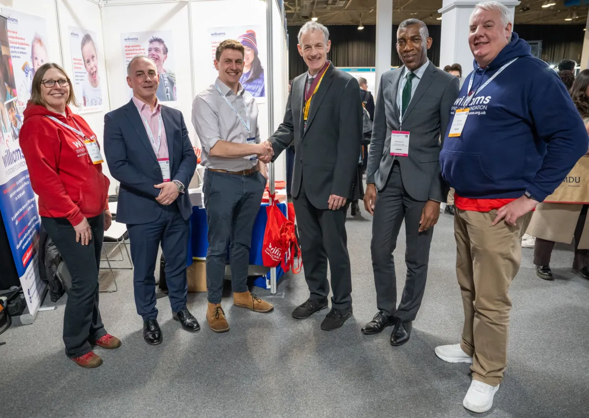 Tommy, Steve Turner and others pose for a photo at Conference