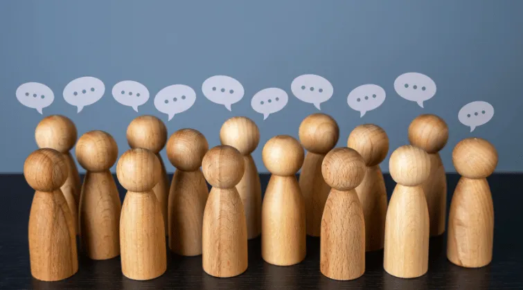 Pawns stand in crowd with speech bubble