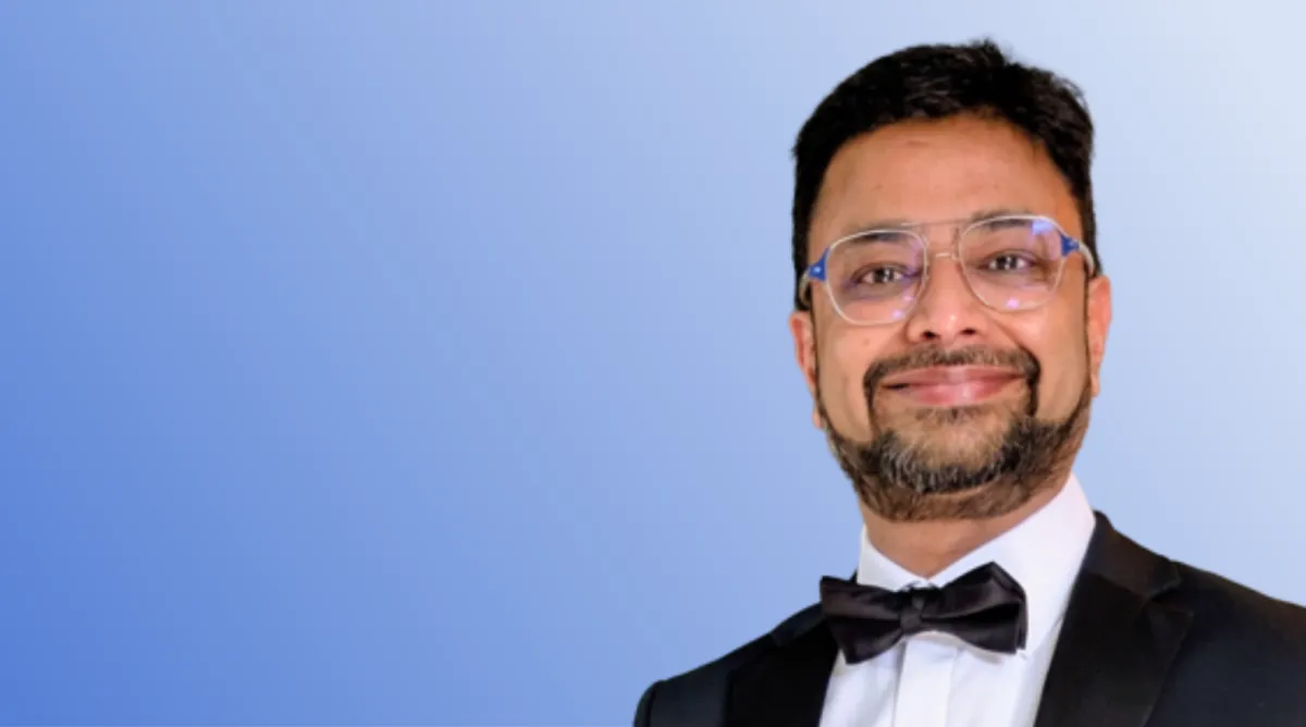 Dr Kumar Swamy on blue background