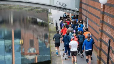 People running along a canal, seen from above