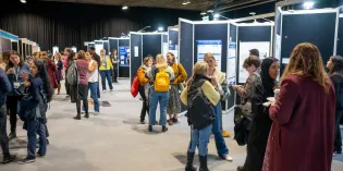 Delegates looking at posters and chatting in an exhibition hall