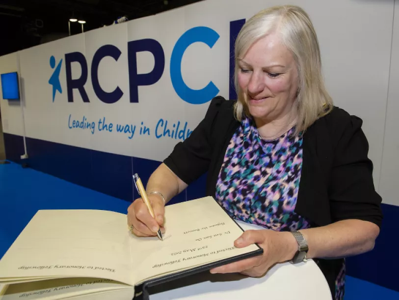 Professor Viv Bennett signs the RCPCH Honorary Fellowship election book